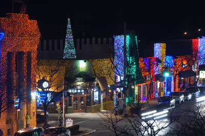 Downtown Rochester during the holiday season with lights of every color on the building